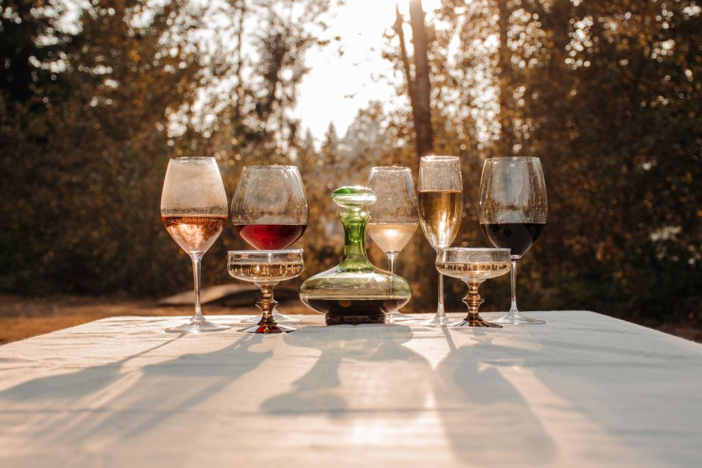 Wine glasses of different shapes and sunset